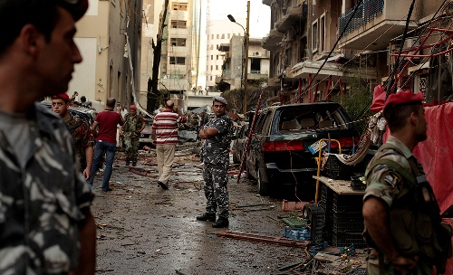 Lebanese security officers guard the site of a car blast in Beirut. (Maya Alleruzzo/AP)