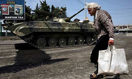 A woman passes a Russian armoured vehicle in Gori, Georgia. Photograph: Pavel Wolberg/EPA